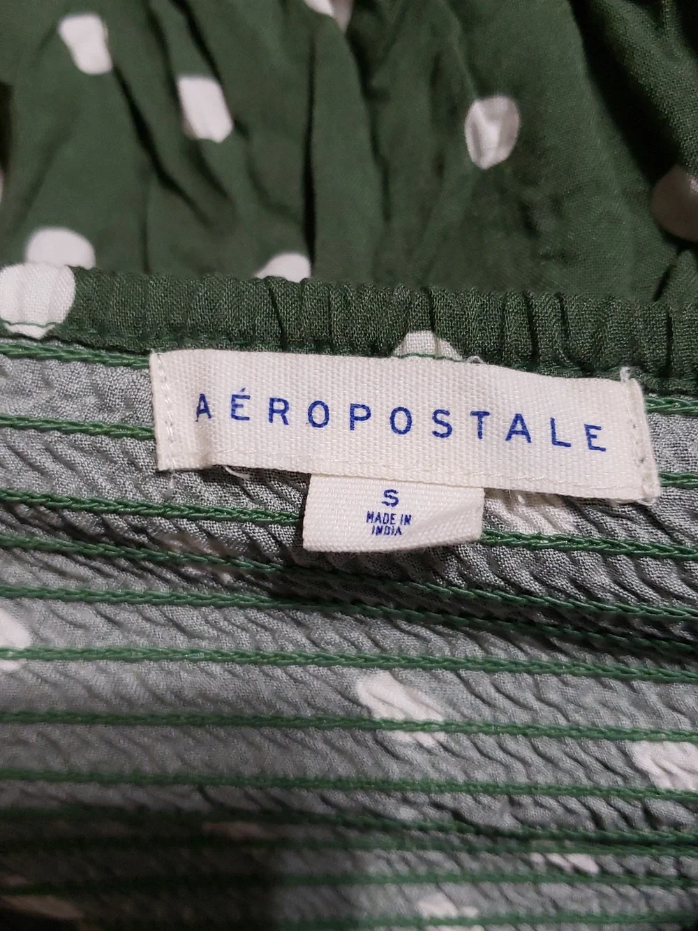 Aéropostale polka dot sundress featuring a ruched design and adjustable straps.